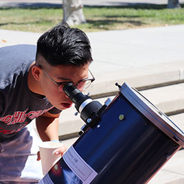Male look through telescope