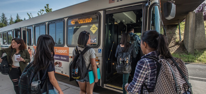 students stepping onto bus