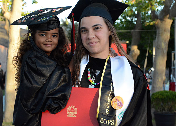 Female graduate holding a young female child