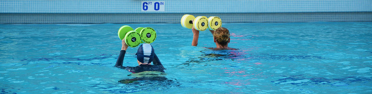 Two women swimming in pool
