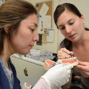 two women working on teeth