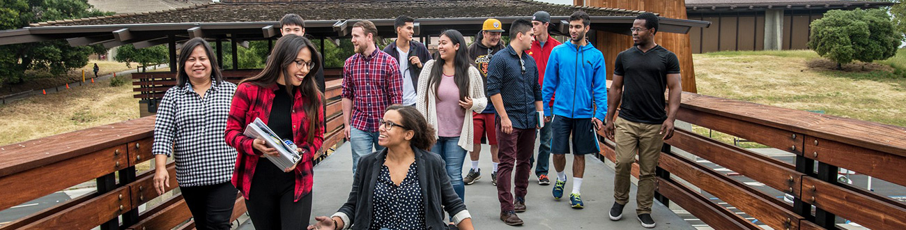 Large group of students crossing a bridge