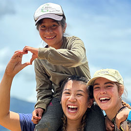 two students with a child on shoulder