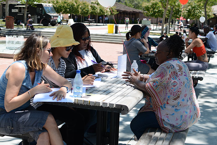 Group of women interviewing a woman at table