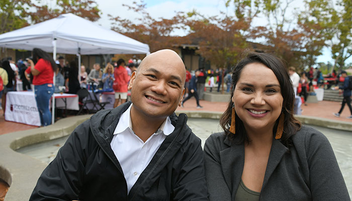 male and female smiling faculty at new student orientation