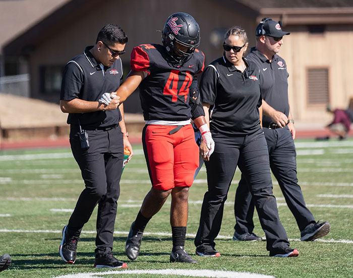 Sports Medicine crew walking with athlete