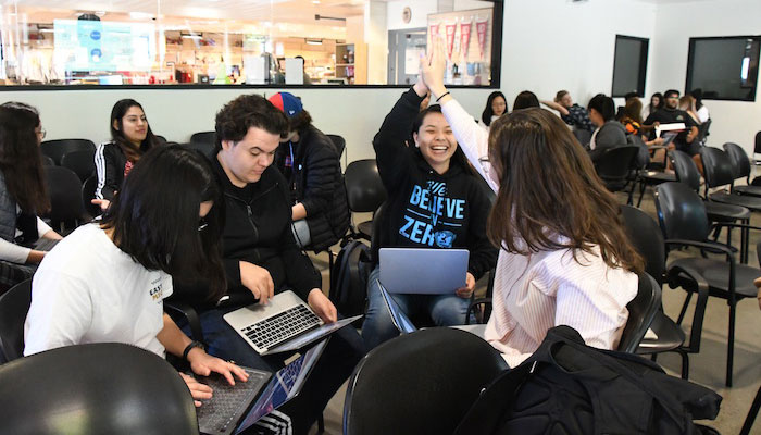 Group of student working and hi-fiving