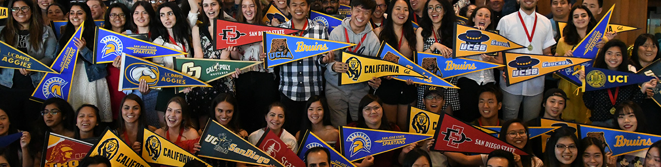 Students holding university pendants